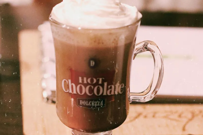 Glass mug of cocoa on wooden surface