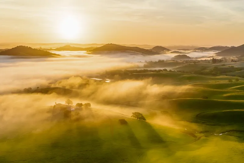 Sunrise over misty mountain valley