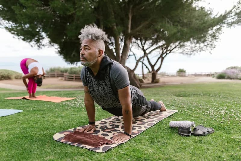 Couple doing outdoor yoga together